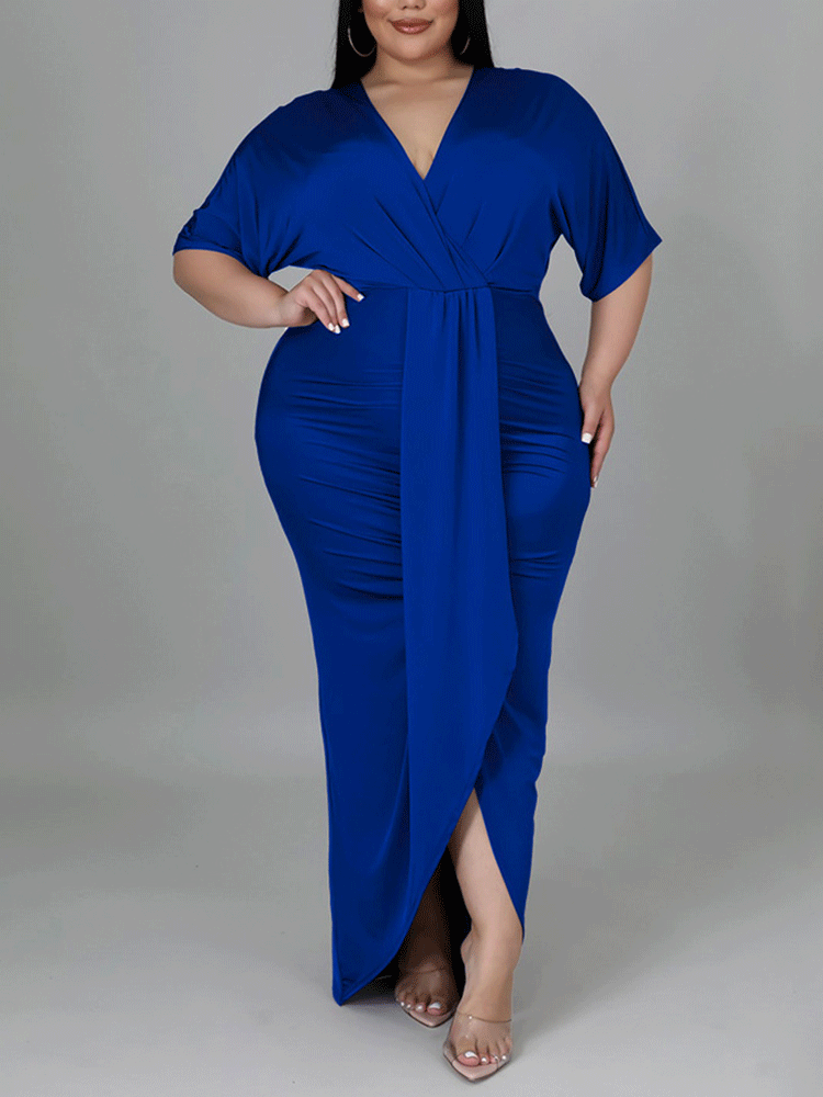 Woman in a royal blue maxi dress with a wrap neckline and high slit