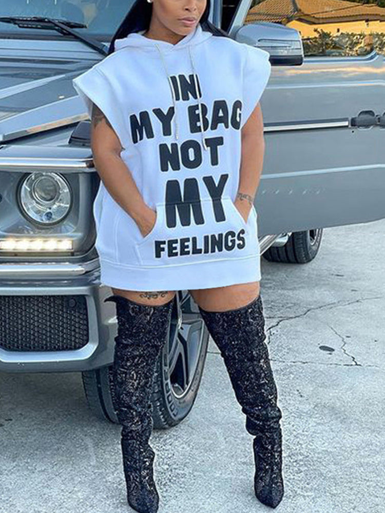 Woman wearing a white hooded mini dress with a graphic print, paired with black knee-high boots, standing next to a vehicle.