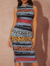 Woman wearing a sleeveless mock neck bodycon sheath dress with an abstract stripe and leopard print pattern, front view.