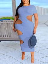 Woman wearing a light blue midi dress with cut-out details on the sides and a ribbed texture.